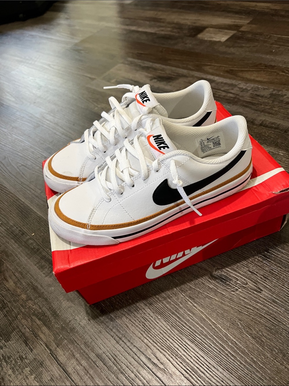 Nike White Sneakers with Black Swoosh and Brown Accent